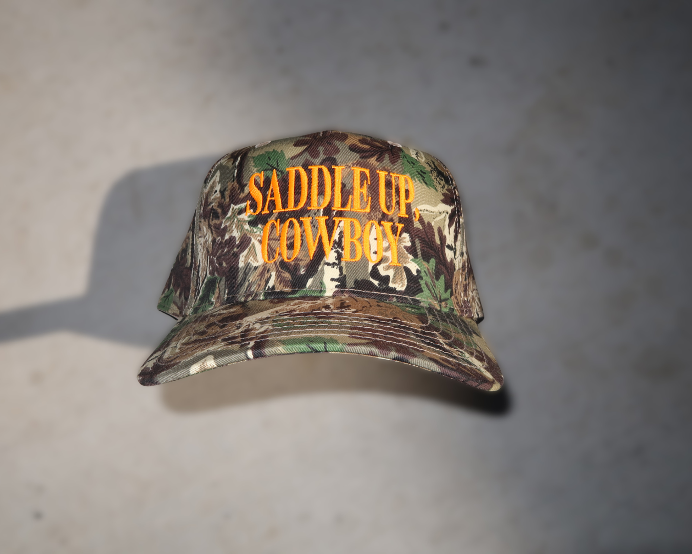 camo trucker hat, hat cowboy snapback, snapback cap country, country western cap, cap woodland hunting, hunting headwear orange, orange embroidered hat, hat rodeo style, style rustic hunting, hunting camouflage baseball, baseball hat outdoor, outdoor ranch accessory, saddle up cowboy